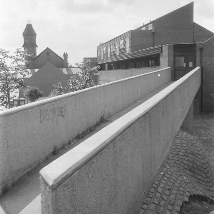 The walkway from Woodborough Road into the Marple Square flats.