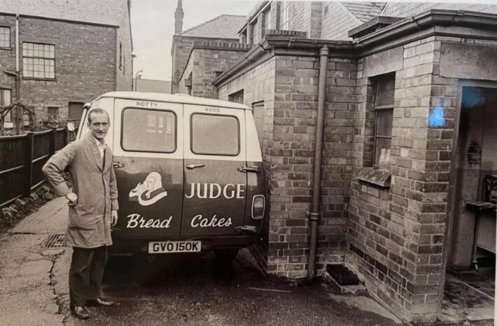 Photograph from 1976 showing an employee next to his delivery van at Judge's Bakery in Mapperley Nottingham